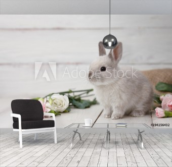 Bild på Easter bunny rabbit with spring flowers on white wooden planks Easter holiday concept